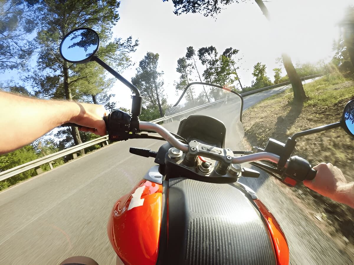 Young man riding on motorbike. POV Original Point of View