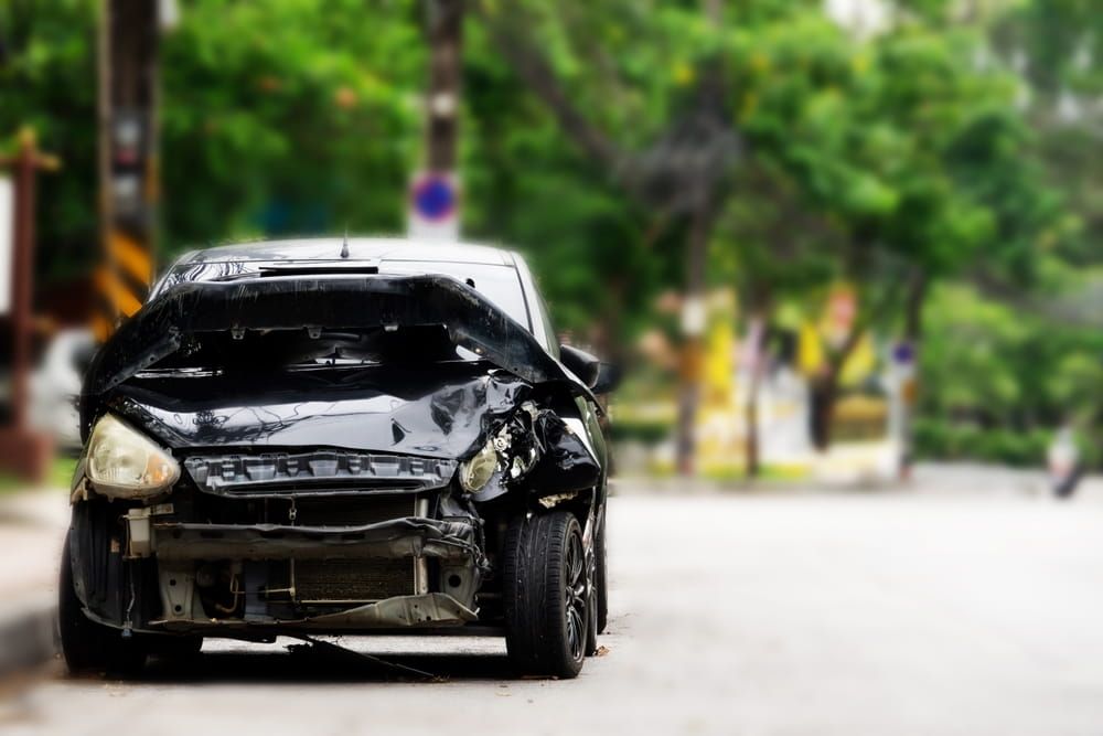 Black car with heavy front-end collision damage