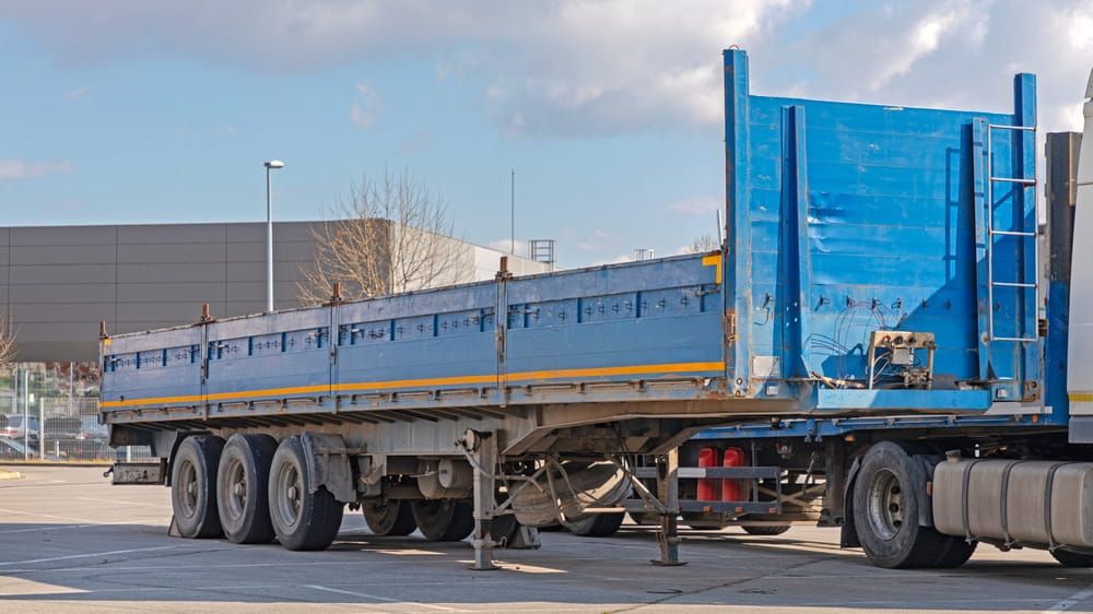Close-up view of a semi-trailer's coupling mechanism and landing gear