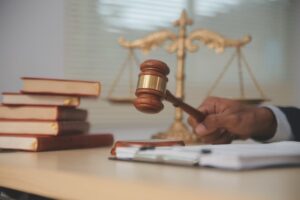 Judge’s gavel, legal books, and justice scales symbolize legal action after a multi-vehicle truck crash. 