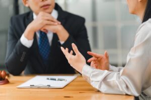 Woman consulting with a lawyer, discussing legal deadlines and options after a personal injury claim.