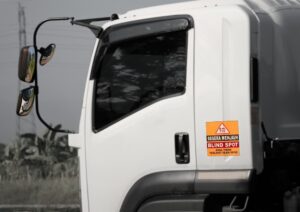 If you can't see the truck's mirrors, you're in a blind spot—stay clear.