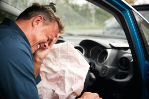 Injured driver in pain after airbag deployment in a car crash